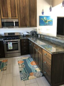 Fully equipped gourmet kitchen with granite counter tops and stainless appliances. Cabinets custom made from Belizean hardwood by local Artisans.