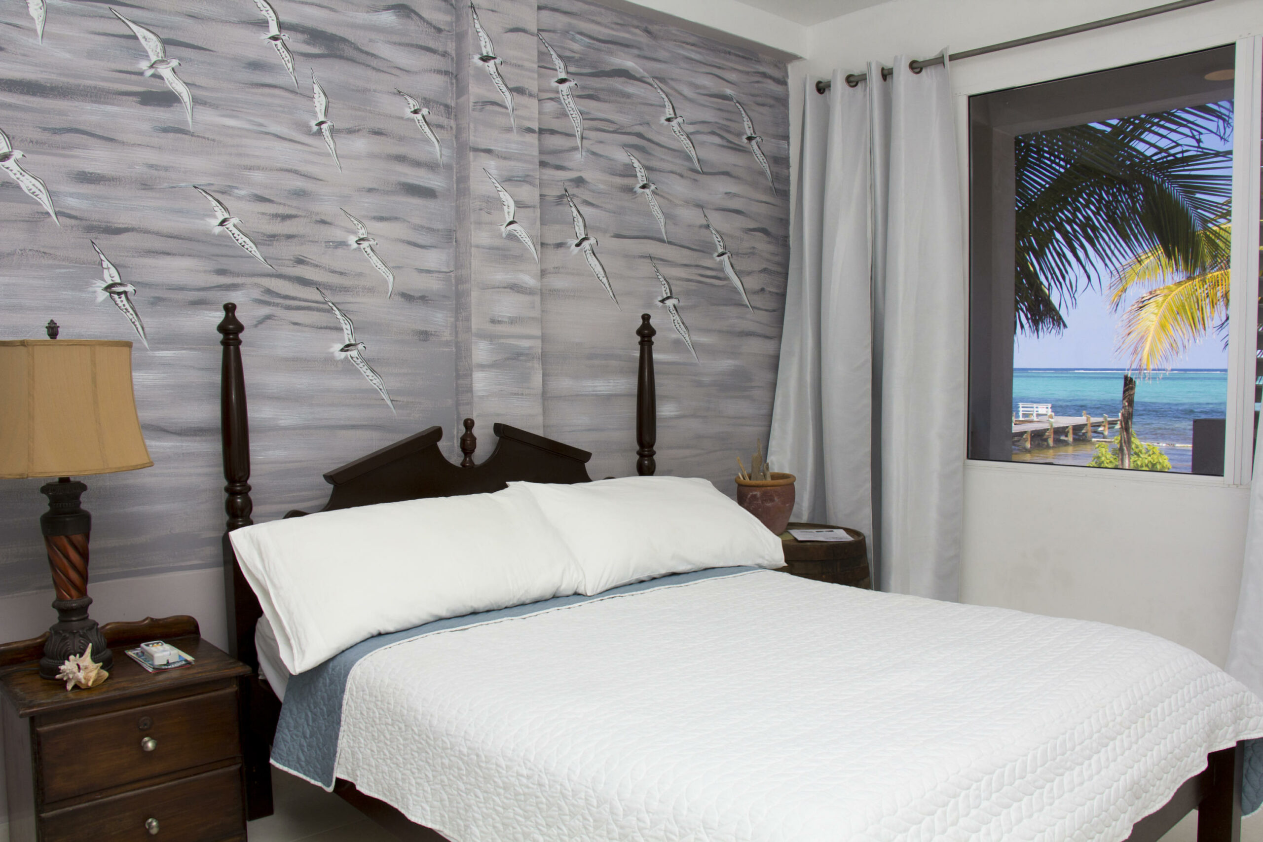Room with a queen bed. Great view of beach and sea.